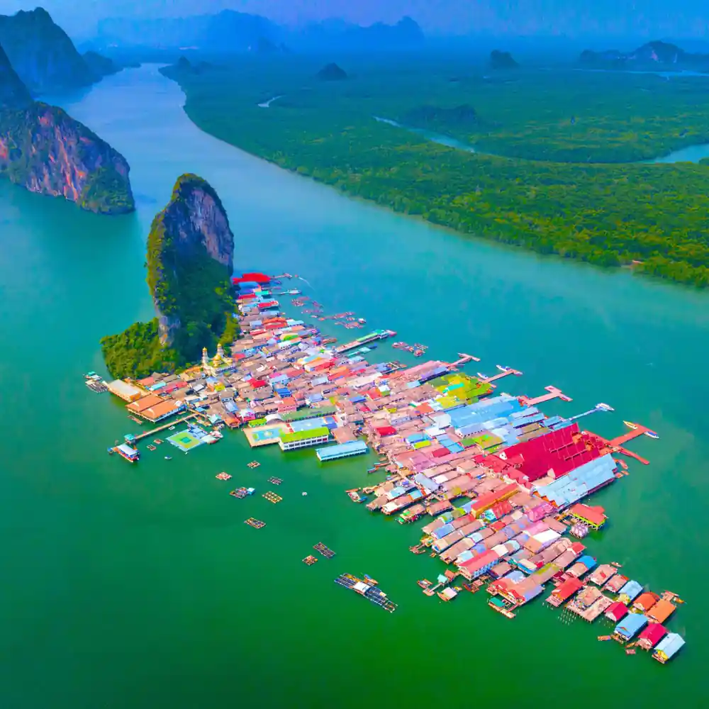 Aerial view of floating village with colorful houses and boats