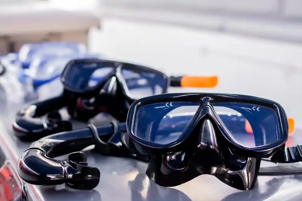 Close-up of black diving masks and snorkeling equipment