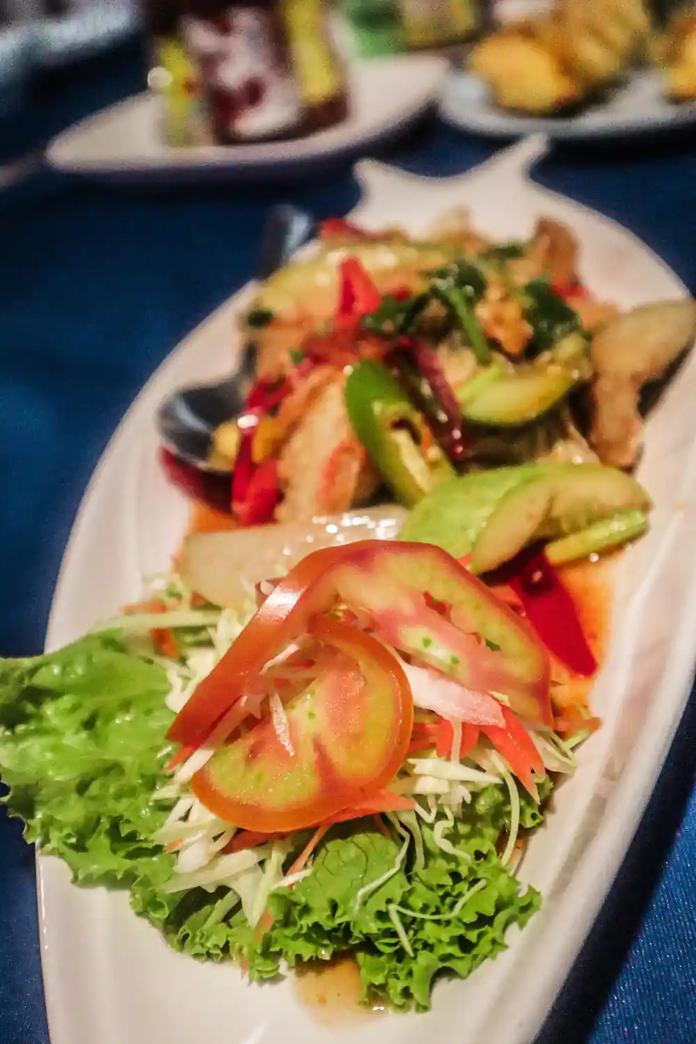 Fresh salad with tomato slices on white plate