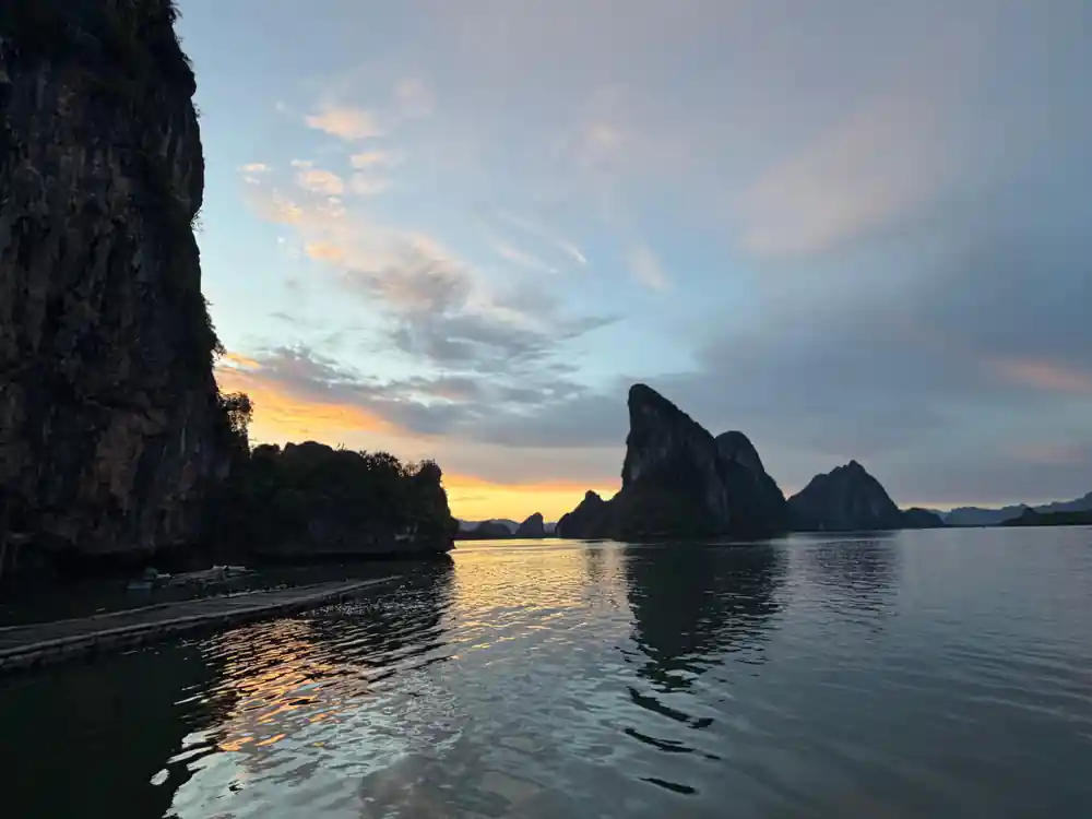 Limestone pinnacles reflected in calm water at sunset