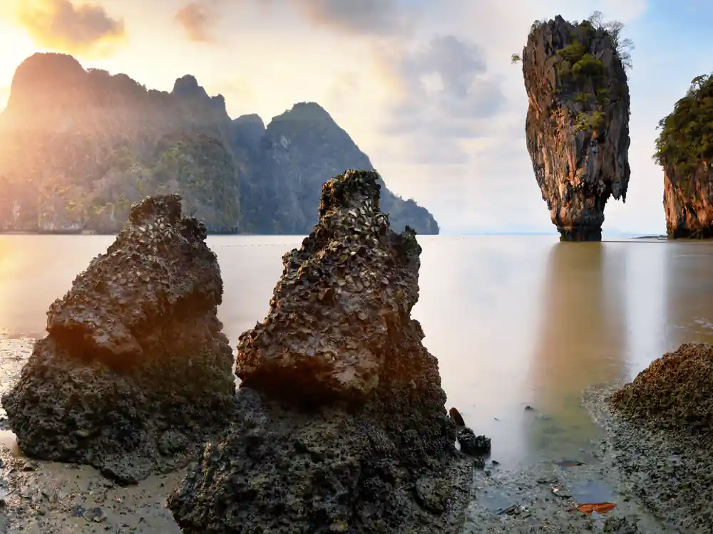 Limestone rocks in shallow turquoise water at sunrise