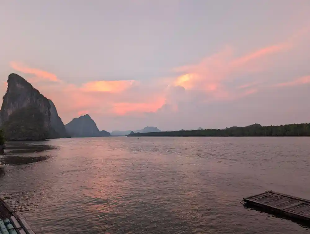 Rocky islands reflected in water at sunset