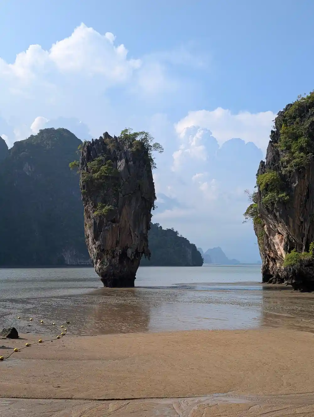 Tall limestone island between beach and water