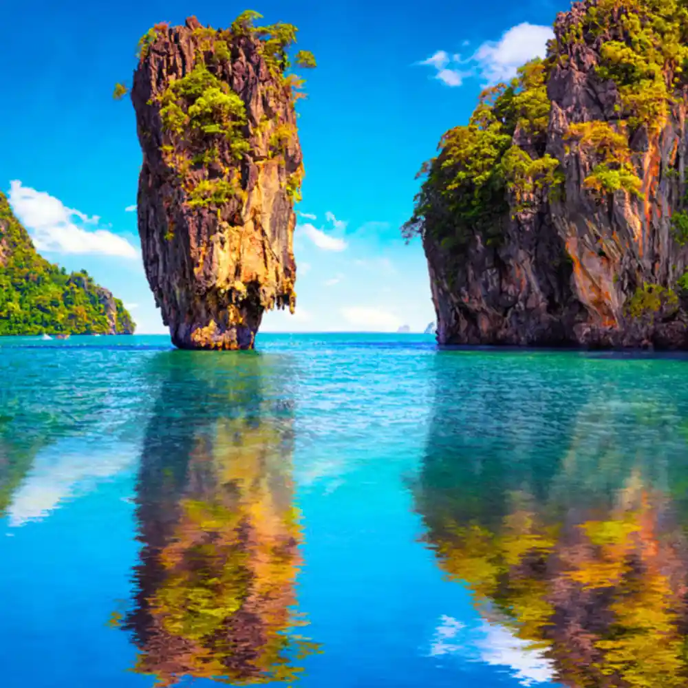 Two tall limestone islands reflected in calm turquoise water